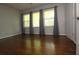 Bright bedroom features hardwood floors, a large window, and neutral gray walls at 2218 Edgemore Se Dr, Atlanta, GA 30316