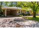 Single-story house showing the side with a convenient carport, a well-kept lawn, and an eye-catching orange front door at 2218 Edgemore Se Dr, Atlanta, GA 30316