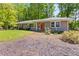 Well-maintained single-story house with a brick facade, complemented by green lawns and a colorful orange front door at 2218 Edgemore Se Dr, Atlanta, GA 30316