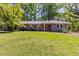 Charming ranch-style home featuring a well-maintained lawn and a vibrant orange front door at 2218 Edgemore Se Dr, Atlanta, GA 30316