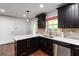 Modern kitchen with dark cabinets, stainless steel appliances, quartz countertops, and a stylish backsplash at 2218 Edgemore Se Dr, Atlanta, GA 30316