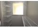 Bright walk-in closet features a frosted window and shelving at 2218 Edgemore Se Dr, Atlanta, GA 30316