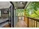 Enjoy the view from this peaceful covered balcony adjacent to bedroom with ceiling fan and wood decking at 224 Cambridge Ave, Decatur, GA 30030