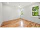 Bright bedroom with hardwood floors, white walls and trim, with two large windows at 224 Cambridge Ave, Decatur, GA 30030