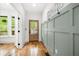 Bright entryway with hardwood floors, board and batten accent wall, and a natural wood door at 224 Cambridge Ave, Decatur, GA 30030