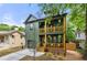 Olive green two-story home featuring double stacked wood porches and lush landscaping at 224 Cambridge Ave, Decatur, GA 30030