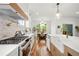 Modern kitchen with quartz countertops, marble backsplash, stainless steel appliances, and hardwood floors at 224 Cambridge Ave, Decatur, GA 30030