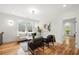 Bright living area features stylish furniture, hardwood floors, and access to outdoor balcony via doorway at 224 Cambridge Ave, Decatur, GA 30030