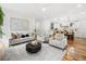 Open-concept living room and kitchen with stylish decor and hardwood flooring at 224 Cambridge Ave, Decatur, GA 30030