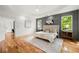 Bright main bedroom with natural light, a tufted headboard, and hardwood floors at 224 Cambridge Ave, Decatur, GA 30030