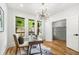 Stylish home office featuring a unique light fixture, natural light, hardwood floors, and desk with chair at 224 Cambridge Ave, Decatur, GA 30030