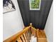 Looking down stairwell with hardwood treads, iron spindles, and paneled accent wall at 224 Cambridge Ave, Decatur, GA 30030