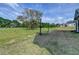 Scenic backyard featuring a lush lawn, mature trees, and picturesque landscaping at 86 Ewing Way, Dacula, GA 30019