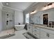 Modern bathroom with a glass-enclosed shower, free-standing tub, and double vanity at 86 Ewing Way, Dacula, GA 30019