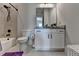 Bathroom featuring vanity with granite countertops, modern fixtures, and a bathtub at 86 Ewing Way, Dacula, GA 30019