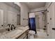 Bathroom with granite countertop, gray subway tiles in the shower, and black hardware at 86 Ewing Way, Dacula, GA 30019