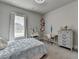 Cozy bedroom with a window, a bed, and a desk area for work or study at 86 Ewing Way, Dacula, GA 30019