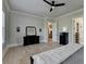 Bright bedroom featuring light wood floors, dark furniture, and a modern ceiling fan at 86 Ewing Way, Dacula, GA 30019