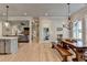 View of a dining area adjacent to the kitchen and living room, showcasing an open-concept layout at 86 Ewing Way, Dacula, GA 30019