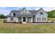 Charming single-Gathering home featuring a well-manicured lawn and a welcoming covered front porch with stylish finishes at 86 Ewing Way, Dacula, GA 30019
