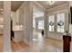 Inviting foyer showcases a view of the living room and kitchen, with hardwood floors and stylish transitional decor at 86 Ewing Way, Dacula, GA 30019