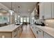 Bright kitchen showcasing a large island, white countertops, and an open layout to the dining area at 86 Ewing Way, Dacula, GA 30019