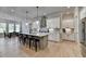 Bright, open kitchen with a large island, stainless steel appliances, and eat in kitchen dining area at 86 Ewing Way, Dacula, GA 30019