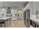 Modern kitchen featuring white cabinets, stainless steel appliances, and light wood flooring at 86 Ewing Way, Dacula, GA 30019