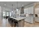 Spacious kitchen with an oversized island, pendant lighting, and modern stainless steel appliances at 86 Ewing Way, Dacula, GA 30019