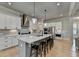 Open kitchen featuring white cabinets, stainless appliances, kitchen island, and seating at 86 Ewing Way, Dacula, GA 30019