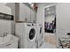 Well-equipped laundry room featuring a sink, washer, dryer, and plenty of storage at 86 Ewing Way, Dacula, GA 30019