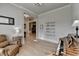 Relaxing living room shows hardwood floors, reading nook, fireplace in the background and access to other rooms at 86 Ewing Way, Dacula, GA 30019