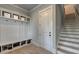 Bright mudroom featuring a storage bench and shelves perfect for organizing shoes and bags at 86 Ewing Way, Dacula, GA 30019
