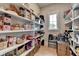 Spacious pantry with ample shelving for organized food storage, with a window at 86 Ewing Way, Dacula, GA 30019
