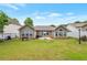 View of the well-maintained backyard with a patio, green grass, and surrounding residential neighborhood at 2416 Centennial Hill Nw Way, Acworth, GA 30102