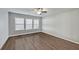 Bright bedroom with hardwood floors, neutral walls, ceiling fan and large windows at 2416 Centennial Hill Nw Way, Acworth, GA 30102