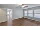 Bedroom featuring hardwood floors, neutral walls, ceiling fan and a view into a sunroom at 2416 Centennial Hill Nw Way, Acworth, GA 30102