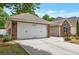 Attached two-car garage with a concrete driveway offers convenience and extra storage space at 2416 Centennial Hill Nw Way, Acworth, GA 30102