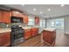 Well-lit kitchen with stainless steel appliances, a tiled backsplash, and a convenient kitchen island at 2416 Centennial Hill Nw Way, Acworth, GA 30102