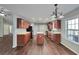 Spacious open kitchen with hardwood floors, stainless steel appliances, an island, and plenty of cabinet space at 2416 Centennial Hill Nw Way, Acworth, GA 30102