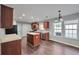 Well-lit kitchen features hardwood floors, a kitchen island, stainless steel appliances, and ample storage at 2416 Centennial Hill Nw Way, Acworth, GA 30102