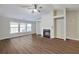 Bright living room features hardwood floors, a fireplace, large windows, and plenty of natural light at 2416 Centennial Hill Nw Way, Acworth, GA 30102