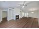 Open-concept living room boasts a modern fireplace, high ceilings, and stunning hardwood floors at 2416 Centennial Hill Nw Way, Acworth, GA 30102