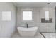 Spa bathroom featuring a soaking tub, tile surround and glass shower door at 2726 Talley Ln, Buford, GA 30519