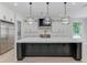 Modern kitchen with a large island, stainless steel appliances, stylish pendant lighting and ample counter space at 2726 Talley Ln, Buford, GA 30519