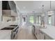 Gourmet kitchen featuring professional-grade appliances, a large island with a sink and sleek countertops at 2726 Talley Ln, Buford, GA 30519