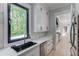 Modern kitchen with sleek countertops, stainless steel appliances, and ample cabinet space with dark accents at 2726 Talley Ln, Buford, GA 30519