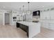 Spacious kitchen features a large island with quartz countertop, stainless steel appliances, and custom cabinetry at 2726 Talley Ln, Buford, GA 30519