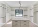 Spacious walk-in closet with custom shelving, drawers, and a center island with a white countertop at 2726 Talley Ln, Buford, GA 30519