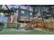 Two-story house with a deck and stairs in the backyard, featuring a well-manicured lawn and mature trees at 1048 Standard Ne Dr, Brookhaven, GA 30319